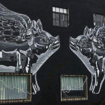 Photo of a large mural of two kissing metallic pigs with wings on a dark background.
