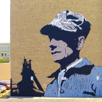 Photo of a graphic mural of a bust of vintage train engineeer.