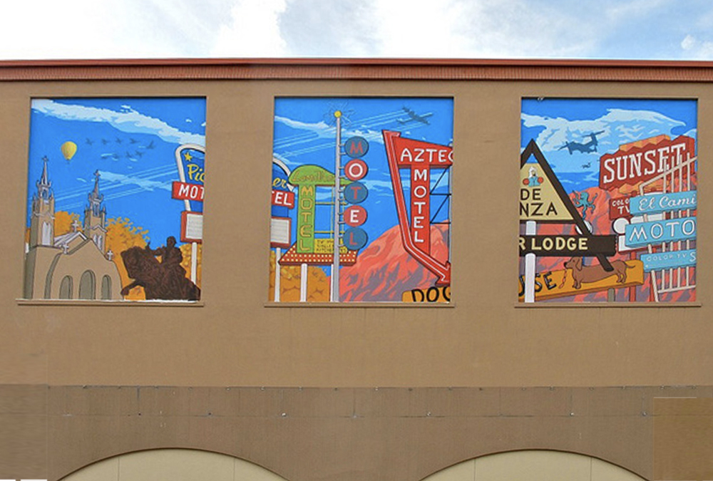 Photo of three murals side-by-side on a building wall of historical signs along Rt66 in Albuquerque.