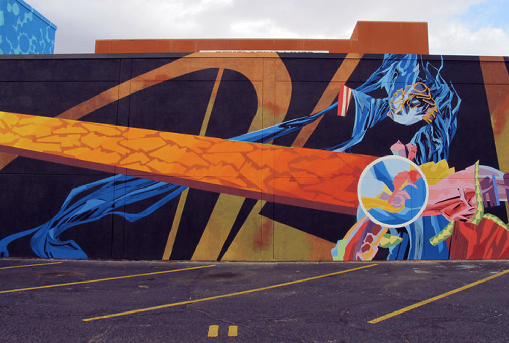 Dramatic and colorful mural of abstract shapes with lots of motion. It looks like outerspace.
