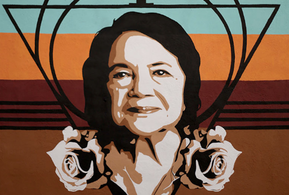 Mural of an older hispanic woman's portrait with roses.