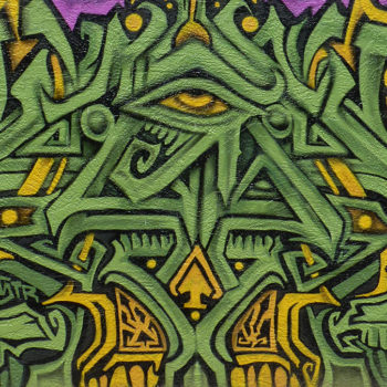 Mural that is green like grass or money that looks like a symbol of the illuninati's all seeing eye.