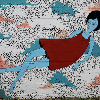 Very friendly mural of a cartoonish young woman floating in a cool dreamscape with cotton candy clouds.