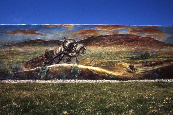 epic scene of horse pulling carriage in desolate landscape mural on wall