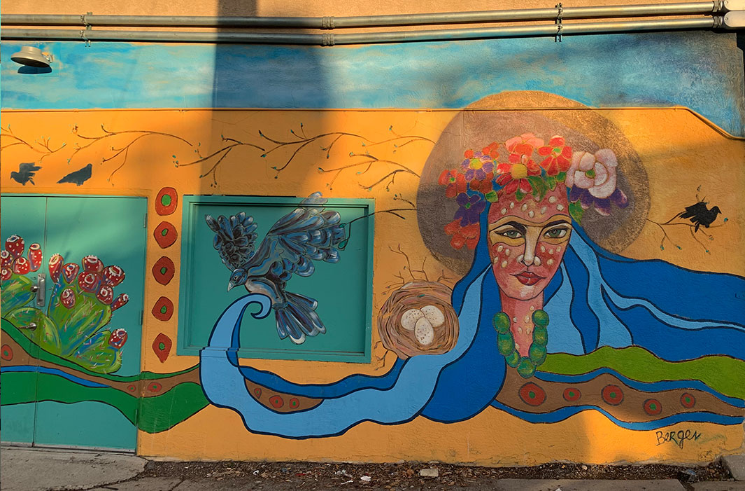 mural of woman with flowing hair and bird with nest